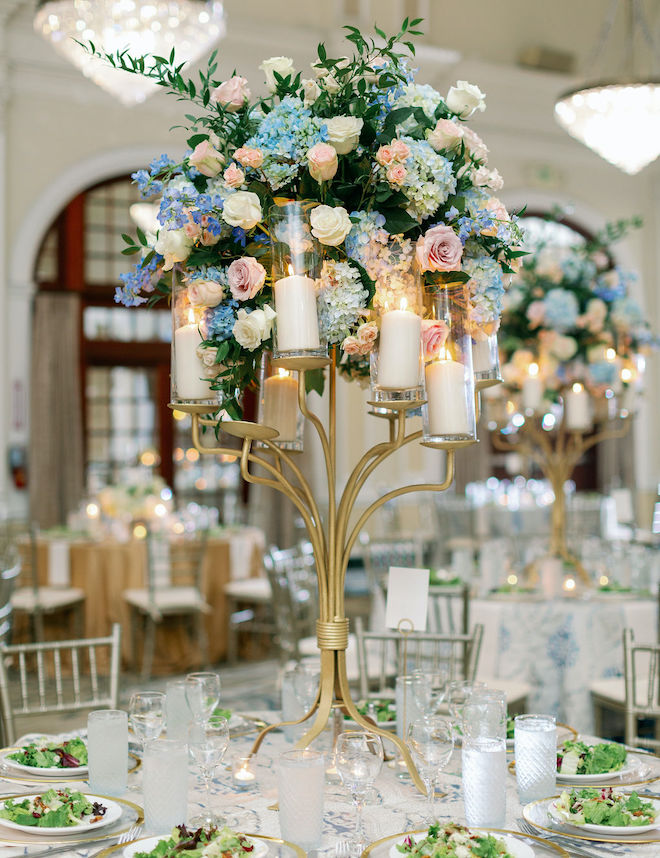 A floral centerpiece with blue hydrangeas, pink roses and greenery by Plants N' Petals. 