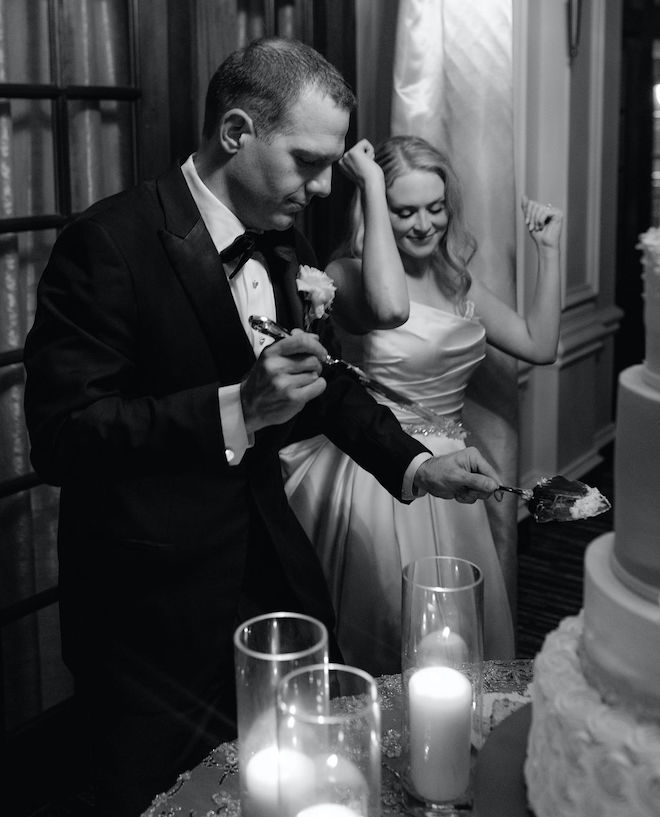 The bride and groom cutting the cake.