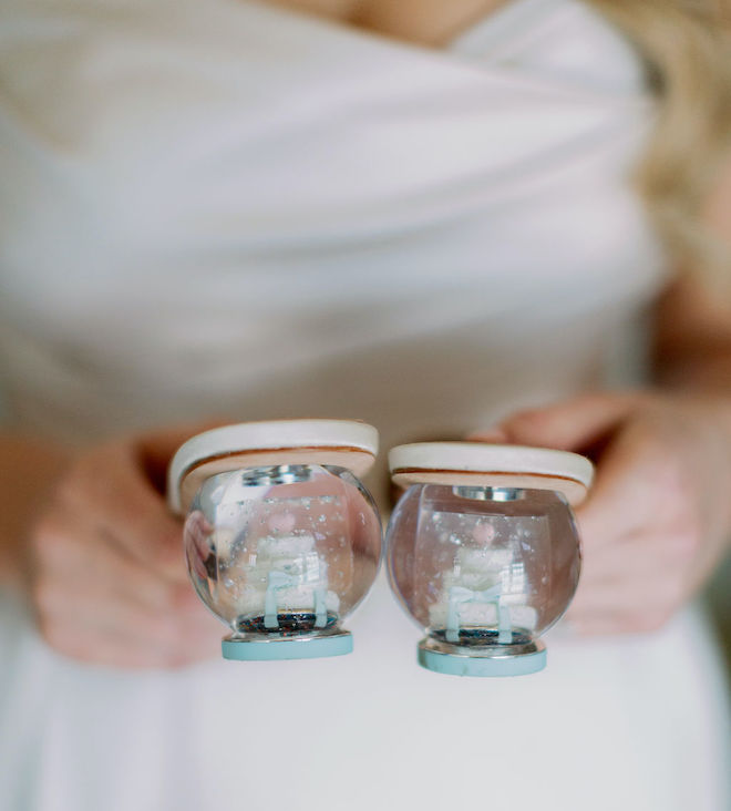 The back of the brides heels with wedding cakes and bows inside them. 