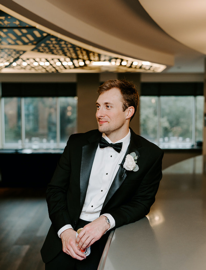 The groom enjoys a drink at the Magnolia Hotel Houston before his wedding ceremony. 