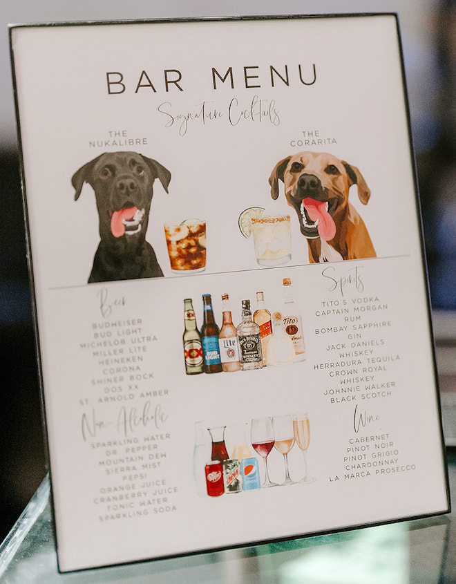 The bride and groom serve signature cocktails featuring their two dogs at their winter wedding reception. 