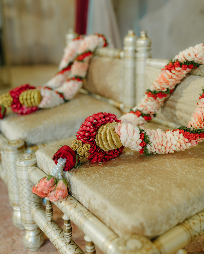 Red, blush and white varmala's sit at the alter for the bride and groom's Hindu ceremony at Bell Tower on 34th. 