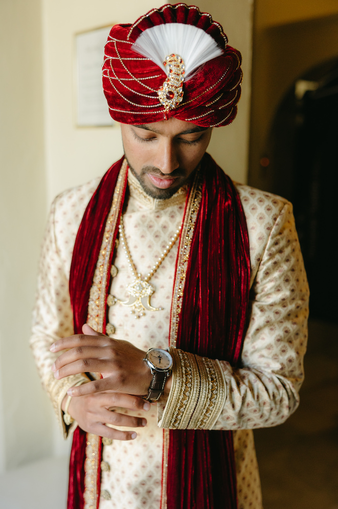 The groom gets ready for his blush, white and red Indian-fusion wedding at the Bell Tower on 34th.