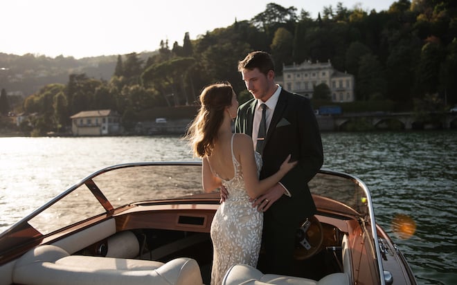 Featured in the Weddings in Houston magazine, the bride and groom ride off in a boat from their wedding on Lake Como. 