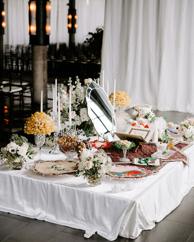 A table is set aside at the wedding reception with family traditions and rituals. 