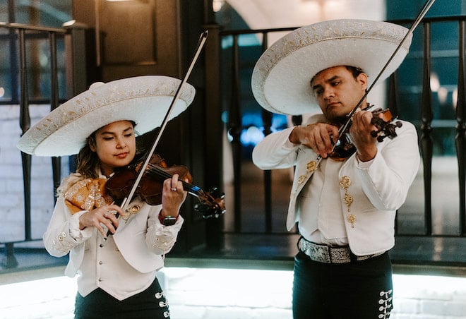 A mariachi band plays at the cocktail hour at the couple's elegant downtown wedding at The Astorian. 