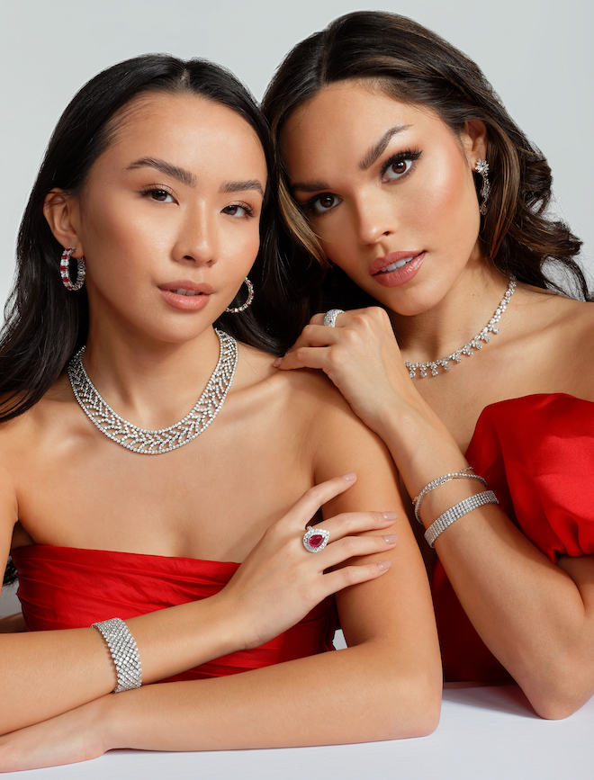 Two women wearing red dresses and diamond jewelry from Houston Jeweler, Shaftel Diamonds.