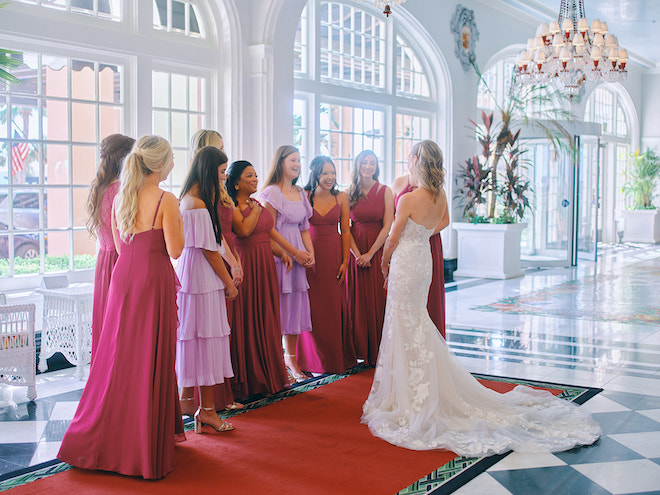 The bridesmaids reacting to the bride's wedding gown in the entryway of the Grand Galvez.