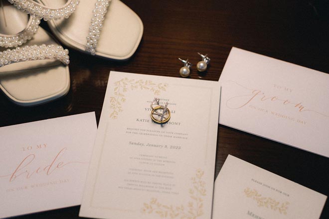 The couple's white and gold wedding stationery for their multi-day wedding in Houston.