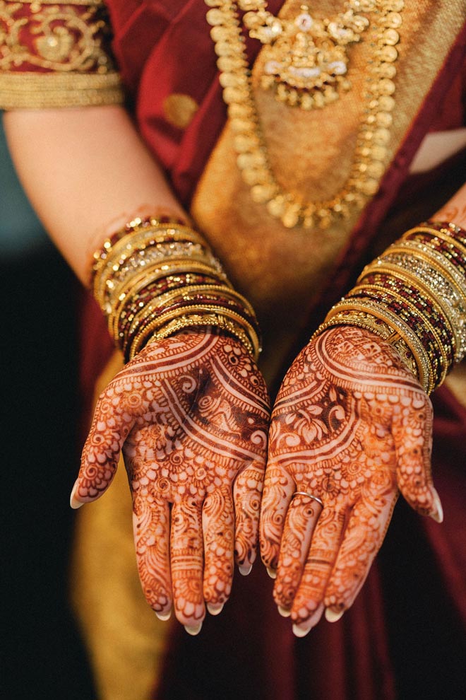The bride's hands are detailed in Henna tattoos for her wedding day in Houston.