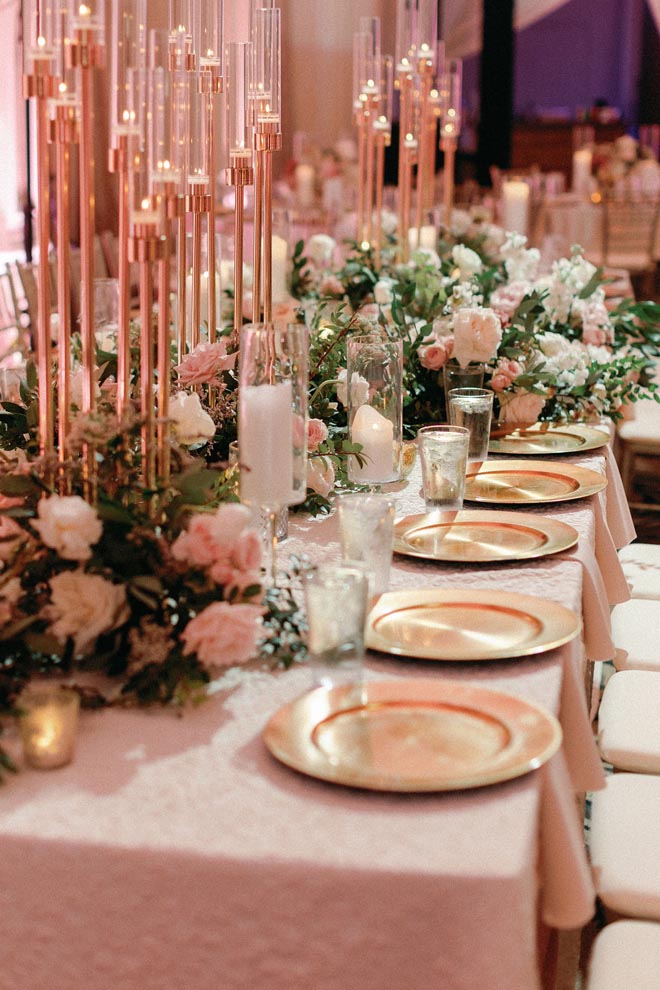 Candlelight and floral centerpieces line the reception tables at The Crystal Ballroom At The Rice.