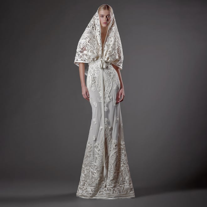 The model wears a signature ribbon work wedding gown with a detachable hood by Naeem Khan. 