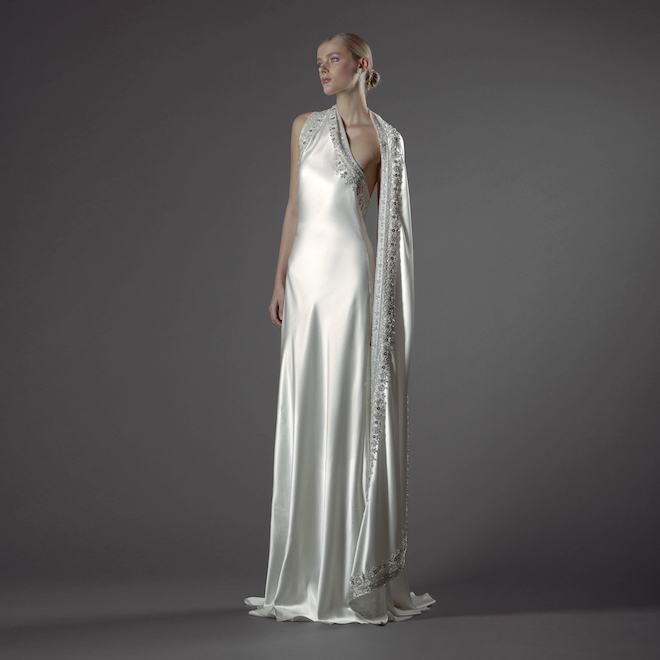 The model wears a designer wedding gown featured in Naeem Kahn's 2024 Fall Bride Collection.