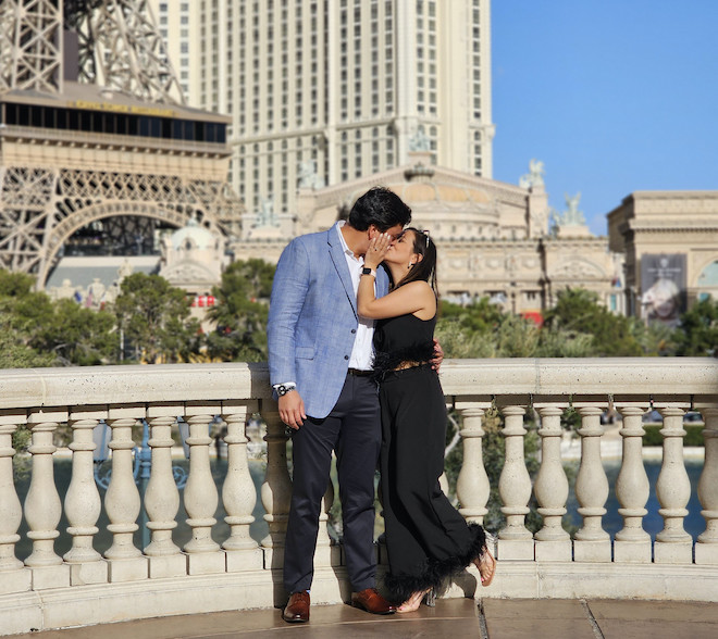 Natalie Hee and her fiance kissing in front of the Eiffel tower in Las Vegas. 