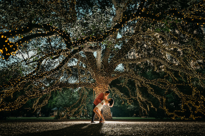 A couple under a lit oak tree at The Houstonian Hotel, Club & Spa.