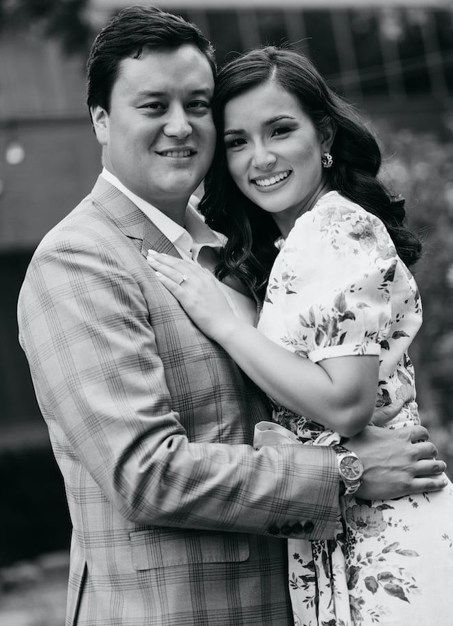 A black and white photo of Natalie Hee and her fiance smiling. 