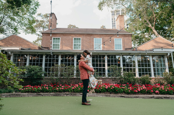 A groom picking up his fiance during an engagement session at The Houstonian Hotel, Club & Spa. 
