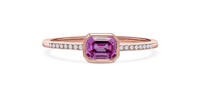 Emerald cut pink sapphire ring with diamonds on the rose gold band. 