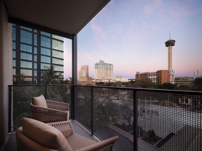 The guest suites at The Plaza San Antonio Hotel & Spa have connected balconies overlooking Downtown San Antonio.