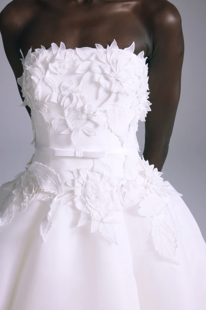 Floral embellishments on a strapless wedding gown. 
