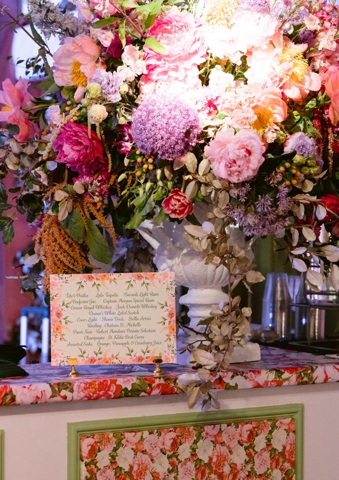 Colorful floral arrangement with a bar menu. 