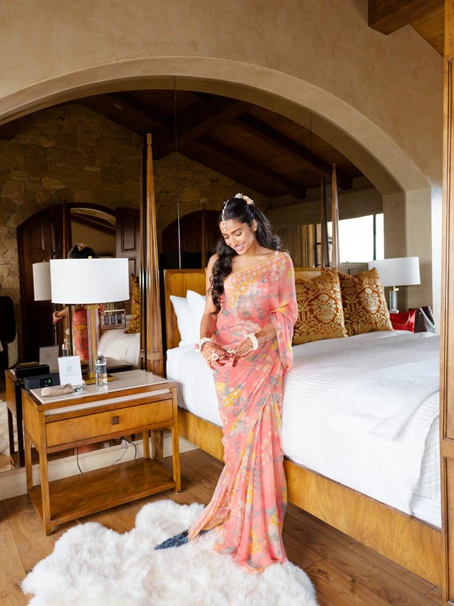 The bride wears peach colored traditional Indian attire for her Haldi ceremony in Malibu. 