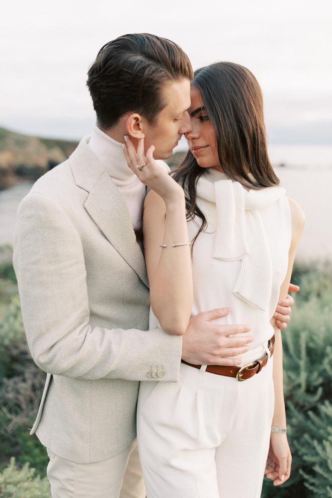 The woman looks into the mans eyes during their California coast engagement by Sean Thomas Photography.