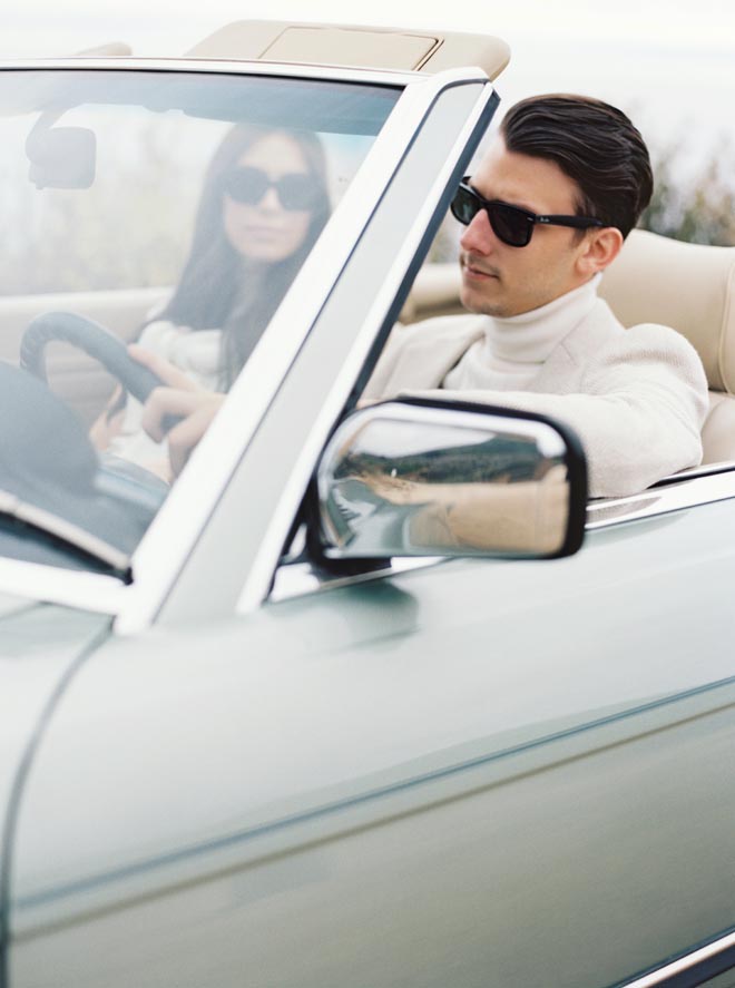 The man drives the vintage Mercedes at their California shoreline engagement session with Sean Thomas Photography.