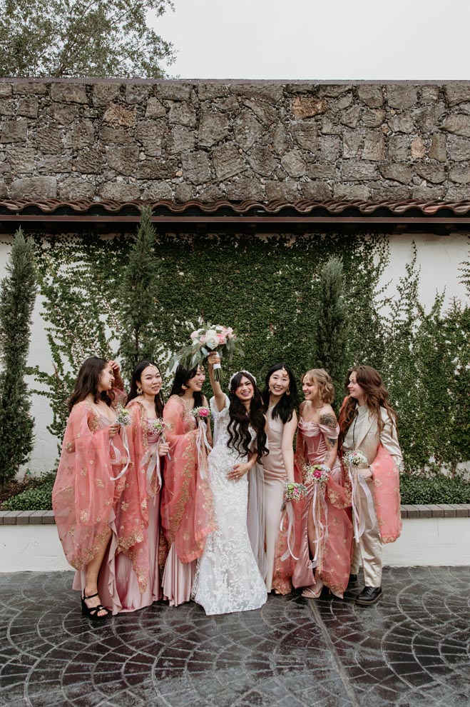 The bride and her bridesmaids cheer outside the Houston wedding venue.