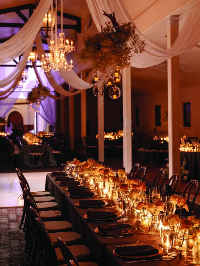 White roses and candlelight decorate the reception tables.