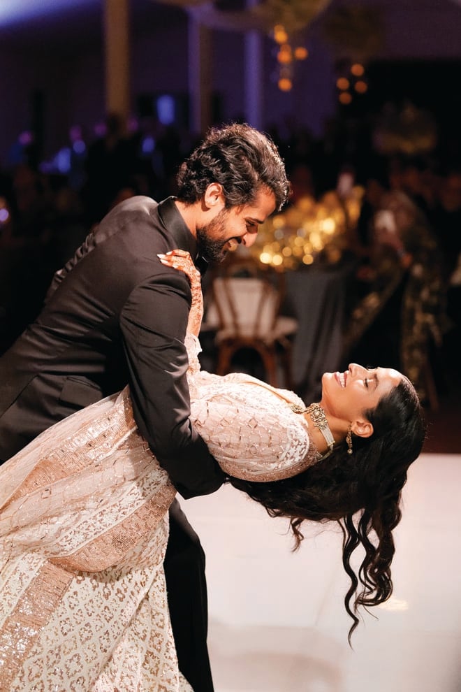 The groom dips the bride at their Malibu wedding reception.