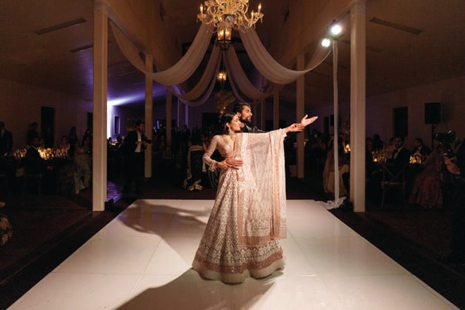The bride and groom share a dance on the dance floor at their wedding reception.