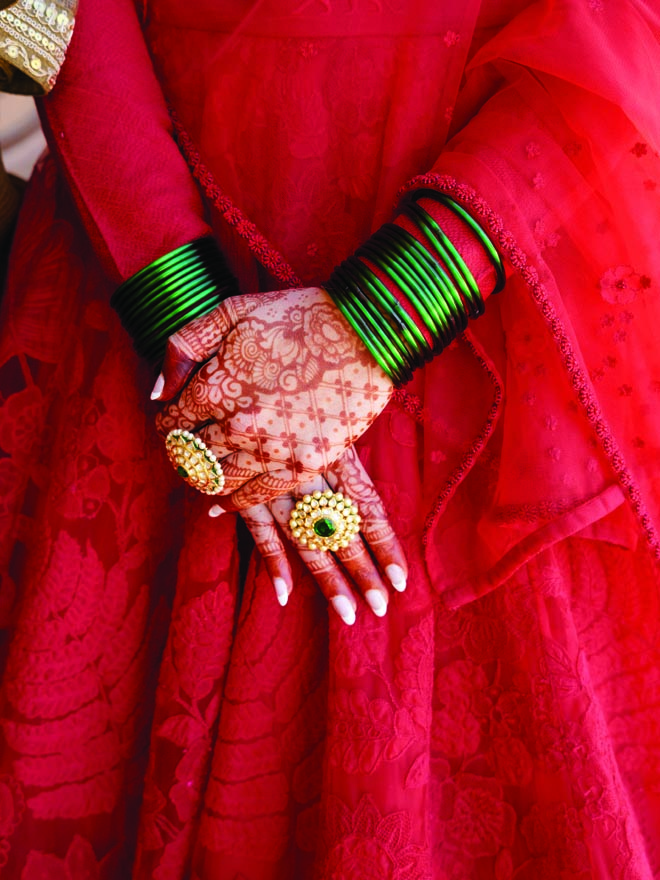 The bride wears Indian wedding jewelry and henna tattoos for her destination wedding in Malibu.