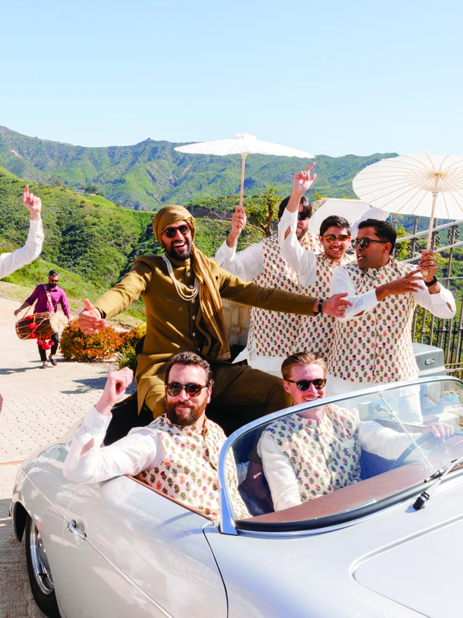 The groom and his groomsmen ride in on a vintage car to their destination wedding in Malibu.