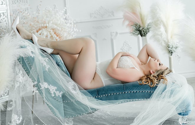 The bride participates in bridal boudoir photography captured with Boudoir by Amy.