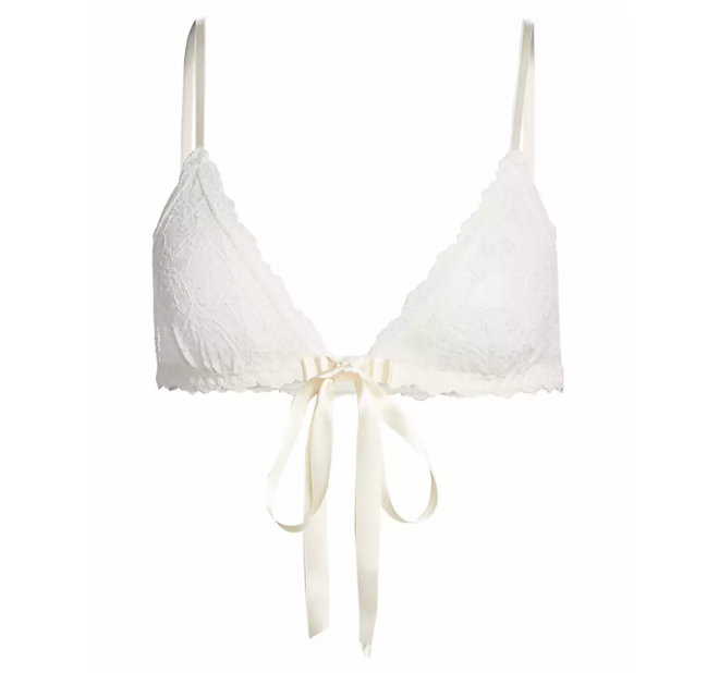 Bridal lingerie: White lace bralette with an ivory bow.