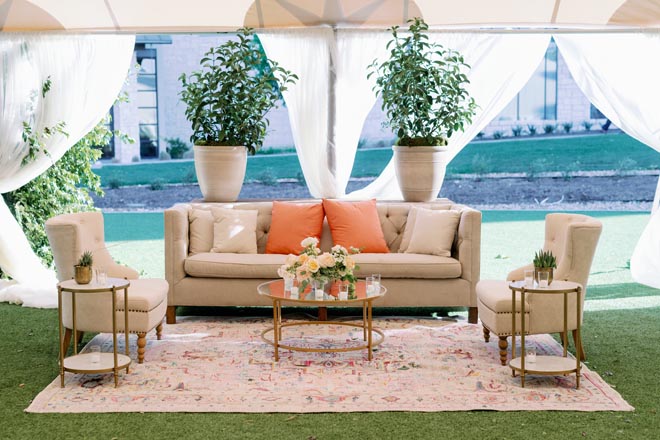 Orange, sage and peach wedding decor detail the tented reception at Omni Barton Creek Resort and Spa.