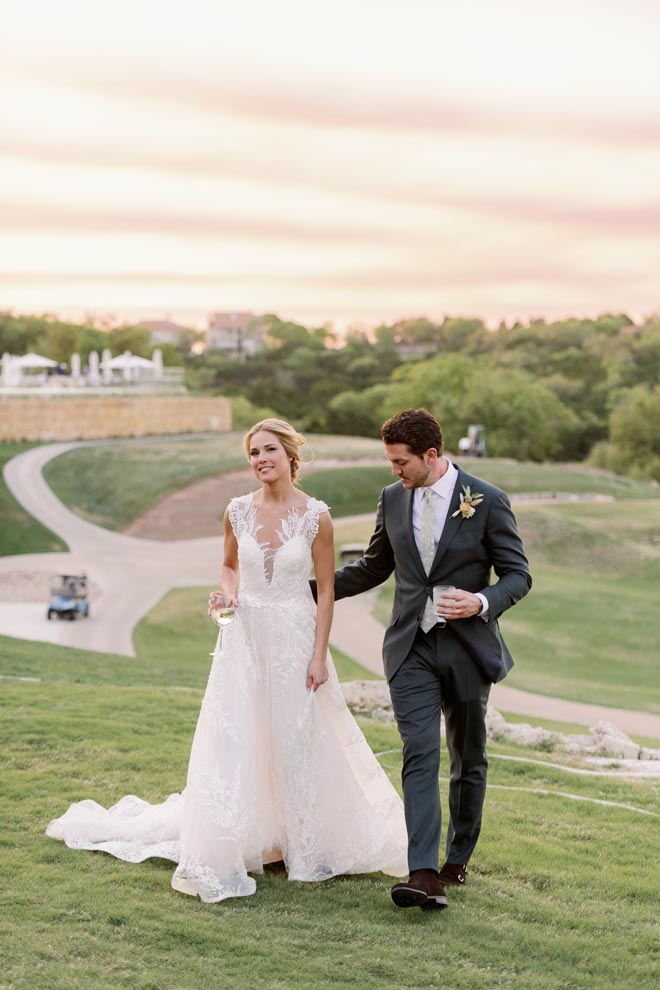 The bride and groom walk on the golf course at the Omni Barton Creek Resort & Spa in Austin, Texas.