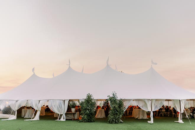 The bride and groom celebrate have a tented wedding reception at the Omni Barton Creek Resort & Spa.