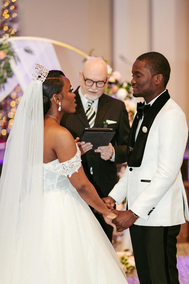 Nicole Johanna Photography captures the bride and groom exchange vows at their wedding ceremony.