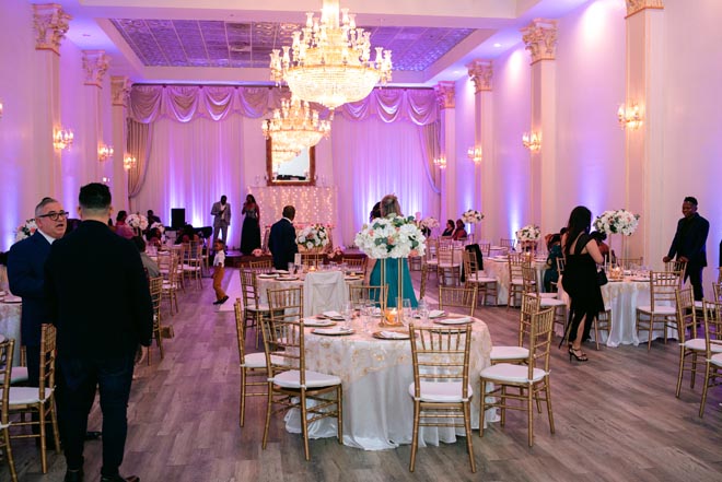 White, gold and purple decor decorate the intimate ballroom wedding. 