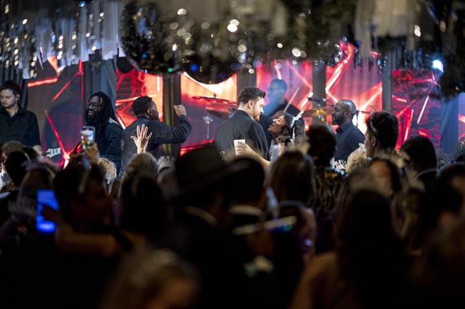 The bride and groom dance to live music with their friends and family at their New Year's Eve wedding.