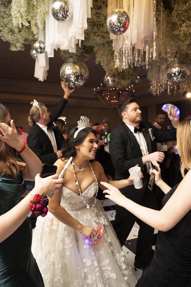 The bride and groom dance with their wedding guests at their New Year's Eve wedding.