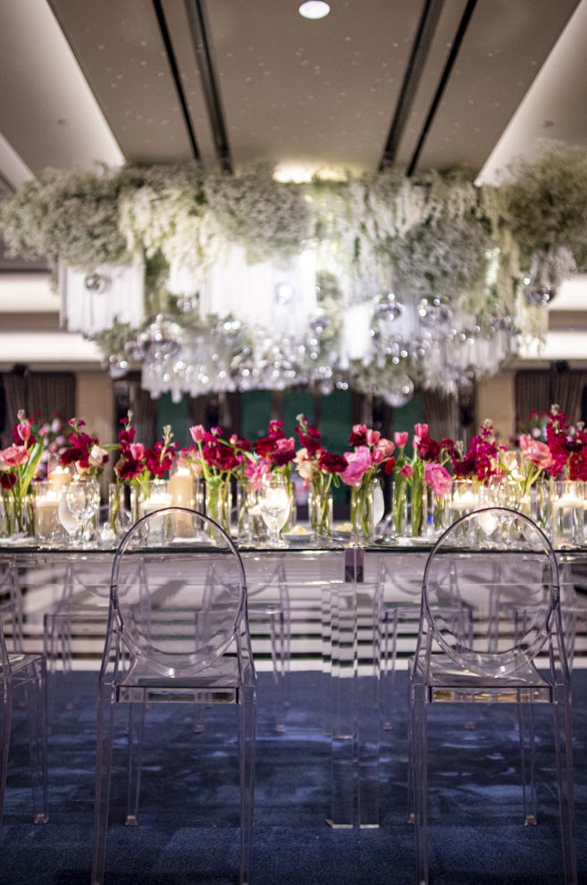 Magenta, burgundy and pink flowers decorate the New Year's Eve wedding at the Houstonian Hotel, Club & Spa's ballroom. 