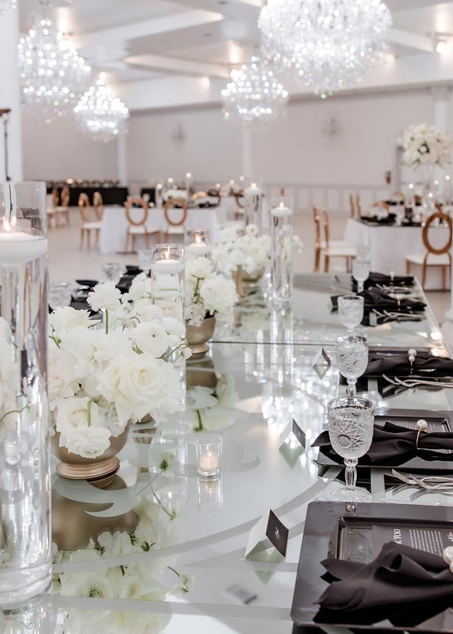 White flowers, black accents and candles decorate the reception tables.
