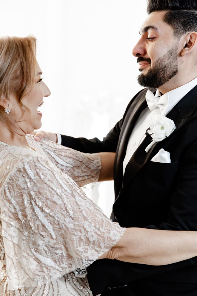 The groom hugs his mother at their first-look before the Persian wedding ceremony.