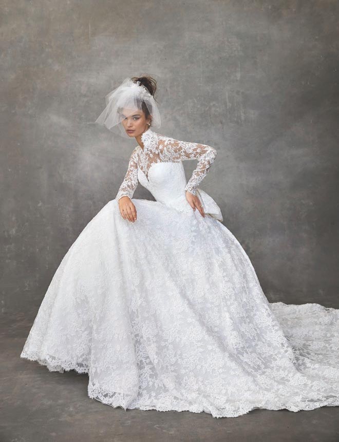 The model wears a lace wedding gown by Sareh Nouri featured in the Weddings in Houston Magazine.