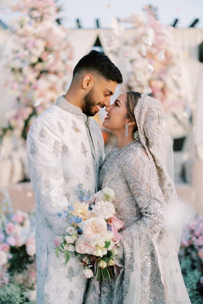 The bride and groom smile at each other at their pastel wedding at the Grand Galvez.