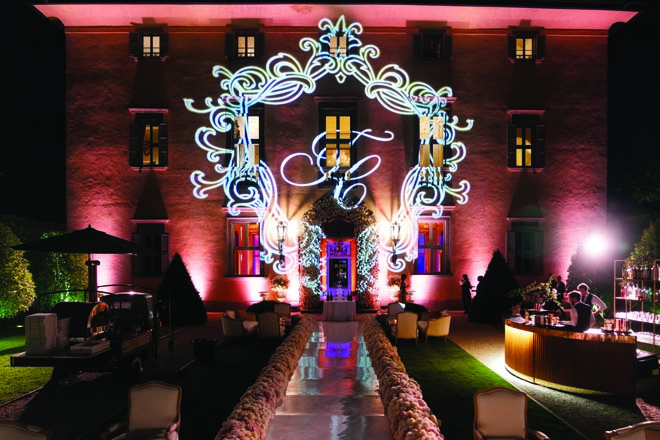 The couple's initials are projected on the wedding Villa Balbiano on Lake Como, Italy.