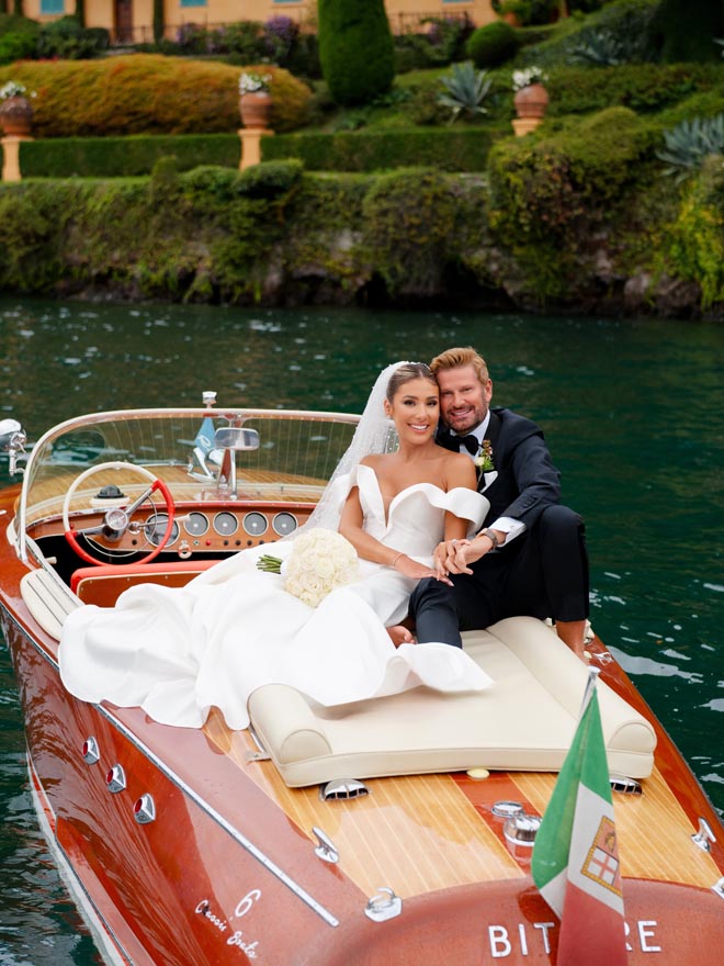 The bride and groom ride off in a boat on Lake Como after their al fresco wedding.
